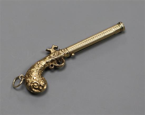 An early 20th century novelty engraved yellow metal cased propelling pencil, modelled as a pistol, 54mm.